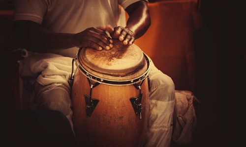 detail of hands playing latin percussion (tumbadora or congas)